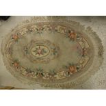 A Chinese superwash rug of oval shape,