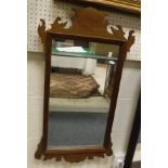 An oak framed wall mirror with blind fretwork carving,