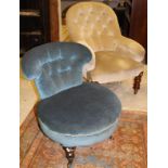 A Victorian buttoned upholstered salon chair on turned front legs to castors,