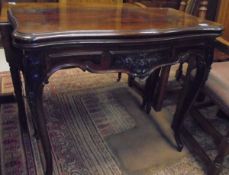 A 19th Century rosewood card table, the shaped top opening to reveal a baize-lined interior,