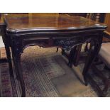 A 19th Century rosewood card table, the shaped top opening to reveal a baize-lined interior,