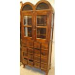 A modern Indian hardwood apothecary cupboard with double-glazed dome top two door upper section