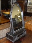 An early 20th Century oak toilet mirror in the 17th Century manner,