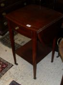 An Edwardian mahogany and inlaid oval drop-leaf table with single end drawer,