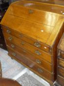 A Georgian oak bureau with the three quarter galleried top above a fall front with fitted interior