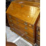 A Georgian oak bureau with the three quarter galleried top above a fall front with fitted interior