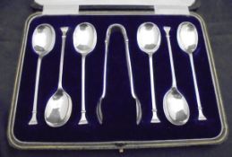 A cased set of six George V silver coffee spoons and tongs (Sheffield 1923) together with a cased