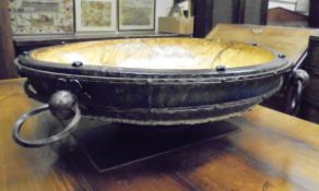 A large treenware and iron bound bowl with dished centre,