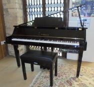 A Yamaha electric piano of baby grand form with a Yamaha Disklavier control unit,