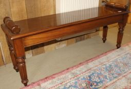 A mahogany window seat in the Victorian manner with scroll handles,