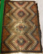 A Caucasian rug, the central panel set with repeating tarantula style motifs on a red ground,