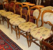 A set of six Victorian stained beech framed balloon back chairs with upholstered seats