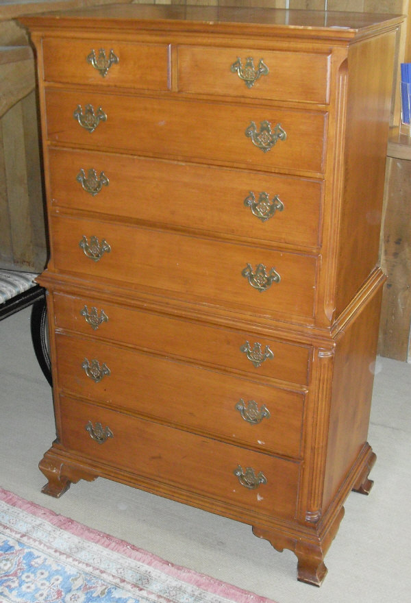 A modern teak chest on chest on squat faceted cabriole legs