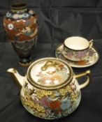 A collection of china wares to include a satsuma tea pot, two similarly decorated cups,