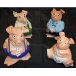 A set of four Nat West piggy banks,