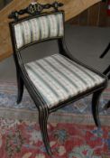 A set of four Regency style ebonised and gilt decorated dining chairs together with a further
