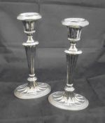 A pair of late Victorian silver sheathed candlesticks in the Adam manner with fluted/fan decoration,