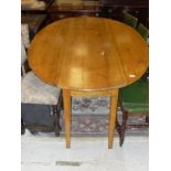 An elm drop-leaf wake style table, raised on square tapered legs,