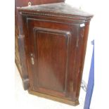 A mahogany wall hanging corner cupboard with single door enclosing shelves