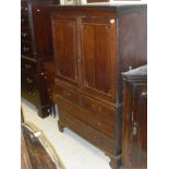 An 18th Century oak cabinet on chest with two cupboard doors above two dummy drawers and two long