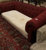 A Victorian Chesterfield button back sofa in red upholstery on turned and ringed front legs to