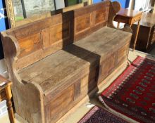 An oak bench with four panelled back (once hand painted) the lift top seat with panelled front,