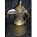 A late 18th / early 19th Century Middle Eastern brass and copper coffee pot with turned brass