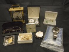 A box containing assoted watches and clocks to include a modern four glass brass carriage clock,