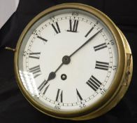 A brass cased ship's style wall clock with Arabic and Roman numerals,