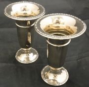 A pair of Edwardian silver trumpet shaped vases on circular feet (Birmingham 1910)