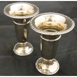 A pair of Edwardian silver trumpet shaped vases on circular feet (Birmingham 1910)