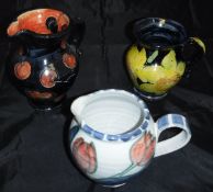 A collection of Rosie Jackson pottery comprising two jugs, one decorated with cherries,