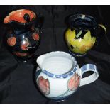 A collection of Rosie Jackson pottery comprising two jugs, one decorated with cherries,