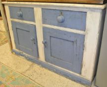A white and blue painted sideboard with two drawers above two cupboard doors to plinth base,