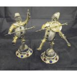 A pair of Continental white metal mounted and jewel set figures of rustic musicians