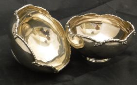 A matched pair of silver sweetmeat dishes with plied rims raised on circular bases (London 1927 and