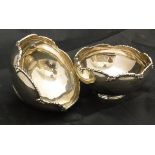 A matched pair of silver sweetmeat dishes with plied rims raised on circular bases (London 1927 and