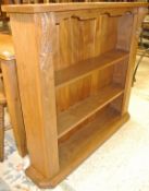 A modern open bookcase, a rustic teak stool, a Victorian walnut framed foot stool,