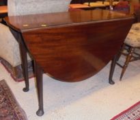 A 19th Century mahogany drop-leaf dining table on turned legs to pad feet