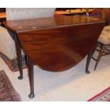 A 19th Century mahogany drop-leaf dining table on turned legs to pad feet
