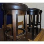 Three modern circular bar stools with brown leatherette seats