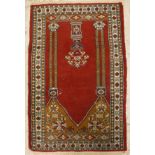 A Persian prayer rug, the central panel set with an urn of flowers, within a columned archway,