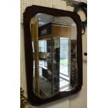 A 19th Century shaped wall mirror in a mahogany frame