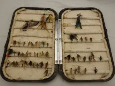 A Hardy "Neroda" oxblood fly fisher's case with chenille lining and a small quantity of trout flies