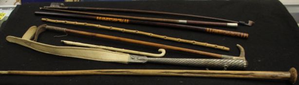 A bundle of assorted sticks, crops, violin bows,