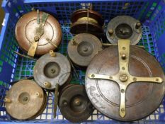 A collection of eight wooden fishing reels,