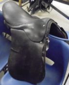 A dressage saddle, together with three boxes of assorted tack, blankets, boots, whip,