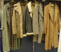A collection of clothing to include a Mulberry trench style coat, two sheepskin jackets, etc,