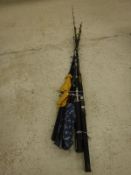 A collection of assorted fibreglass fishing rods including spinning rods and boat rods