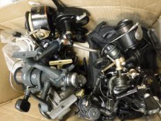 A collection of seventeen fixed spool reels to include examples by Mitchell, Shimano, ABU,